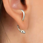 Silver snake hoop earring worn on ear