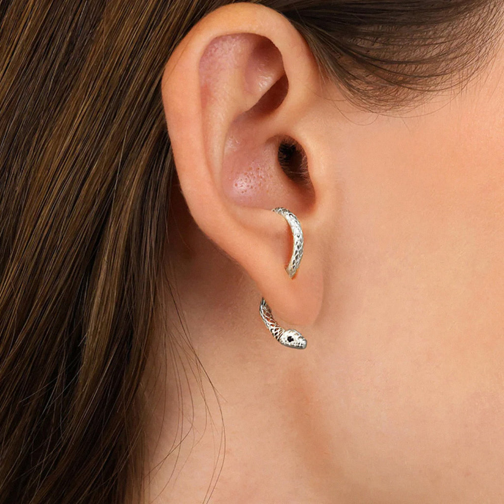 Close-up of silver snake hoop earring