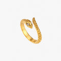 Gold textured snake ring with crystal detail on white background