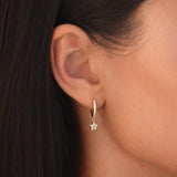 Gold pavé huggie earrings with star-shaped cubic zirconia charm