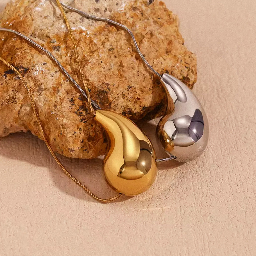 Silver and gold teardrop pendant necklaces side by side